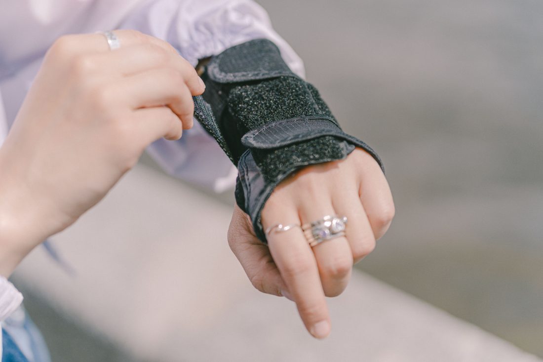 A person's wrist in a fabric medical support brace
