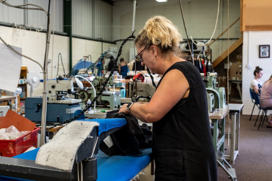 A factory worker operating machinery on a production line