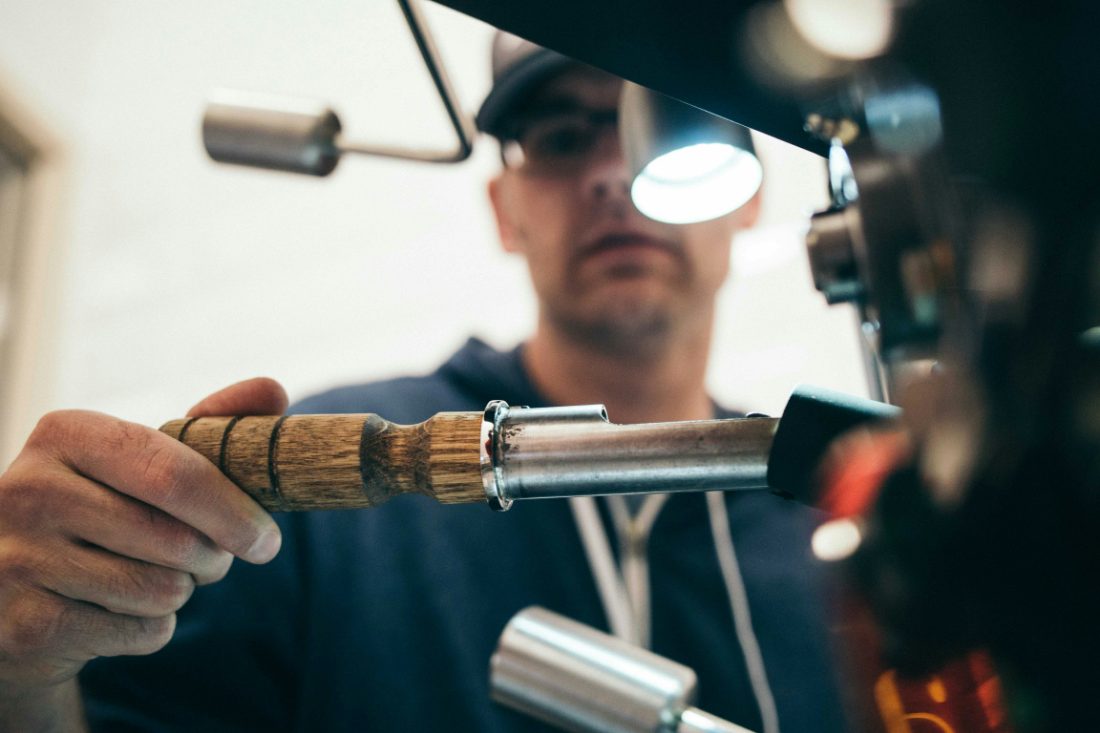 A welder working with sparks flying in an industrial shop