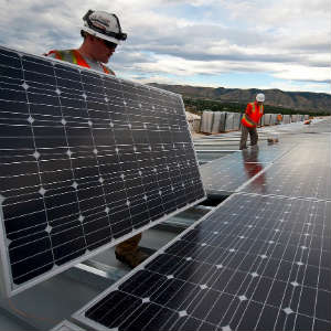construction workers installing solar panels