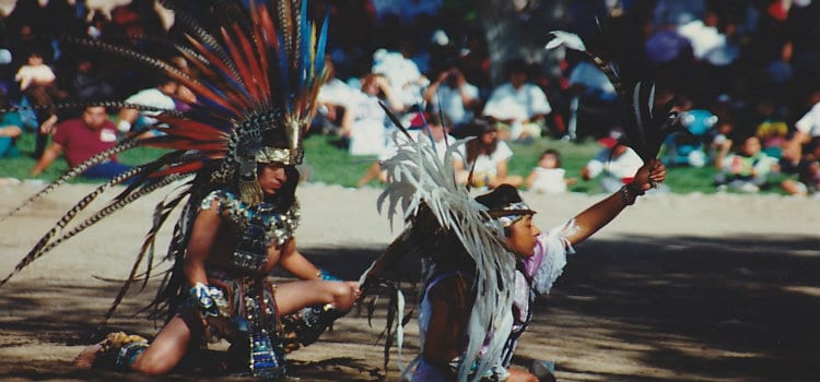 native americans dancing in headdresses